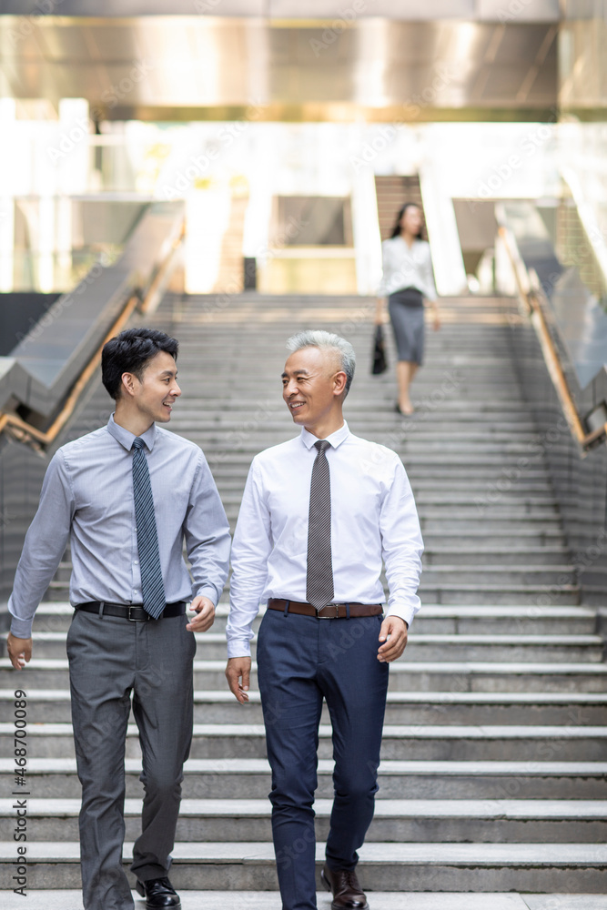 Business people walking outdoors Business people walking outdoors