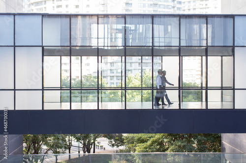 Confident business people talking in office building