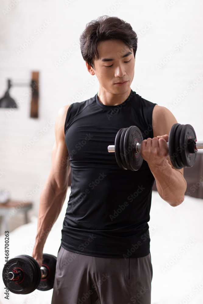 Young Chinese man exercising at home Young Chinese man exercising at home