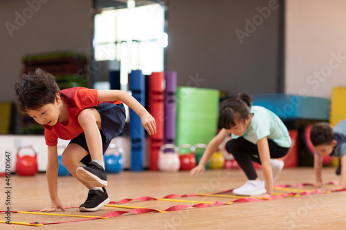 Cute children having exercise class in gym