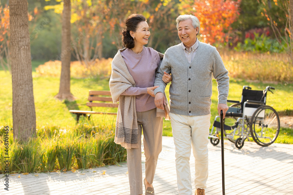 Cheerful senior Chinese couple relaxing in the park Cheerful senior Chinese couple relaxing in the park