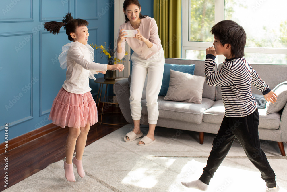 Young Chinese mother and her children relaxing at home Young Chinese mother and her children relaxing at home