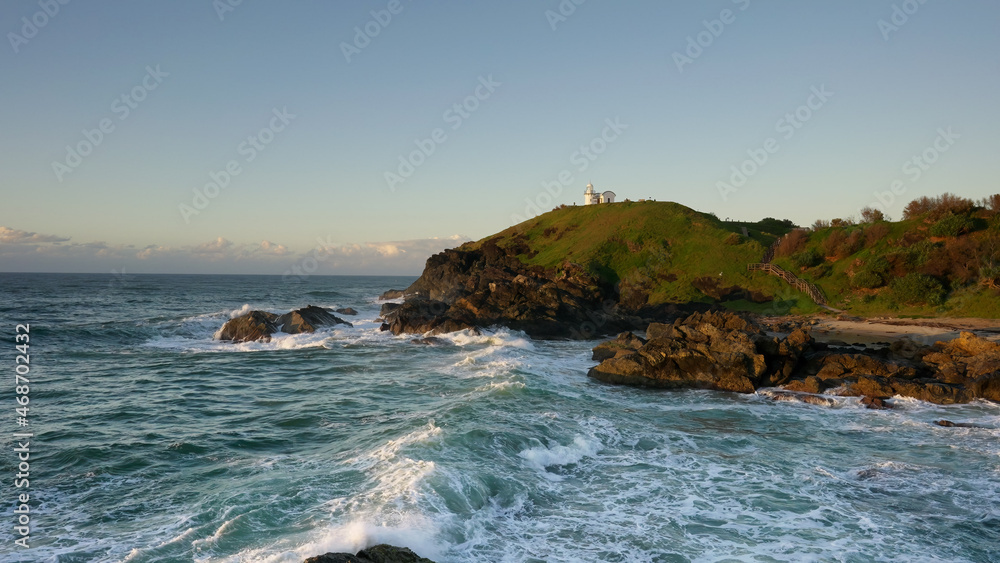 wide angle view of tacking point lighthouse at sunrise
