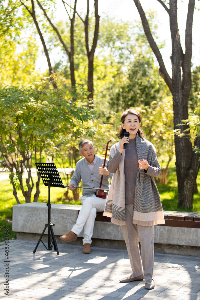 Cheerful senior woman singing with microphone Cheerful senior woman singing with microphone