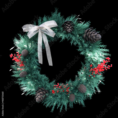 green christmas wreath with a white ribbon isolated on black