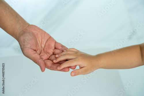 Mother and Child’s holding hands on white background, Mother and Kid hand on white background. 