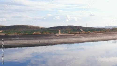 Drone Flying Over Water Reservoir To Reaveal Citrus Farm Fields In Spain. photo