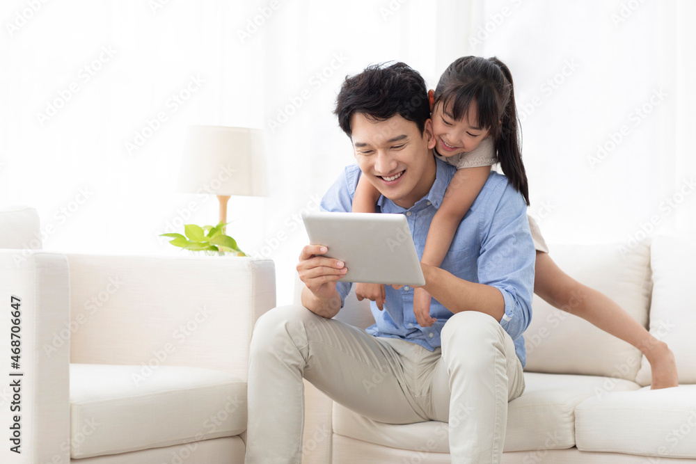 Cheerful father and daughter using digital tablet Cheerful father and daughter using digital tablet