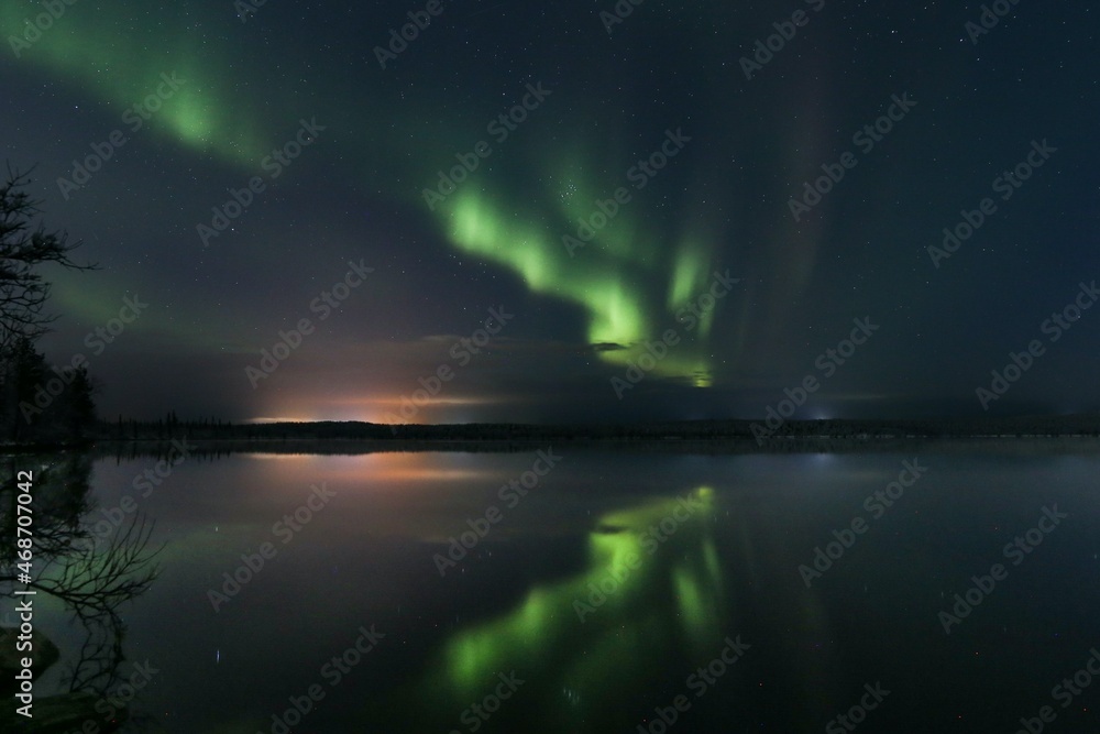 Aurora with reflection in the water over a lake
