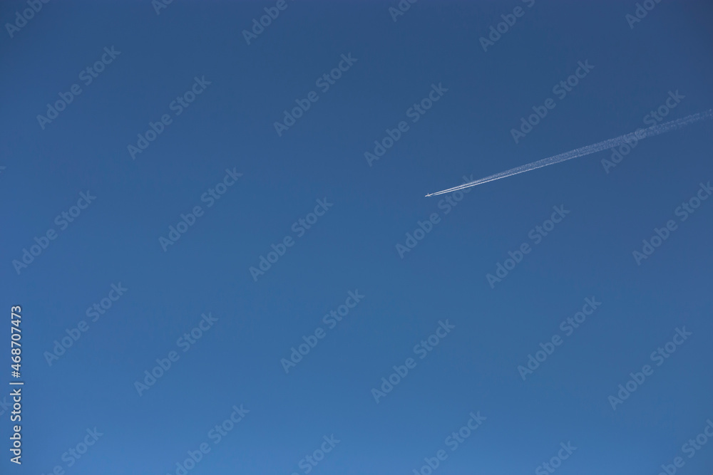 White contrail from an airplane in a clear blue sky. White contrail from an airplane in a clear blue sky.