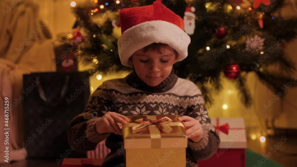 Portrait of excited and amazed little boy looking inside magical Christmas present box. Families and children celebrating winter holidays. Portrait of excited and amazed little boy looking inside magical Christmas present box. Families and children celebrating winter holidays.