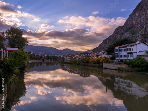 traditional ottoman houses at sunset and their reflections in the water in Amasya