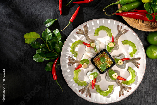 Raw Shrimp in fish sauce and many herbs. A delicious recipe from Asia and spices ingredients for cooking on dark black wooden table background, Thai food, Asian foods, Thailand restaurant menu