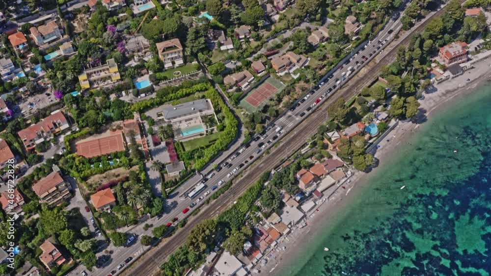 Eze France Aerial v26 vertical straight down view capturing waterfront hillside housing neighborhood, tilt up reveals rocky mountain cliffs - July 2021 Eze France Aerial v26 vertical straight down view capturing waterfront hillside housing neighborhood, tilt up reveals rocky mountain cliffs - July 2021