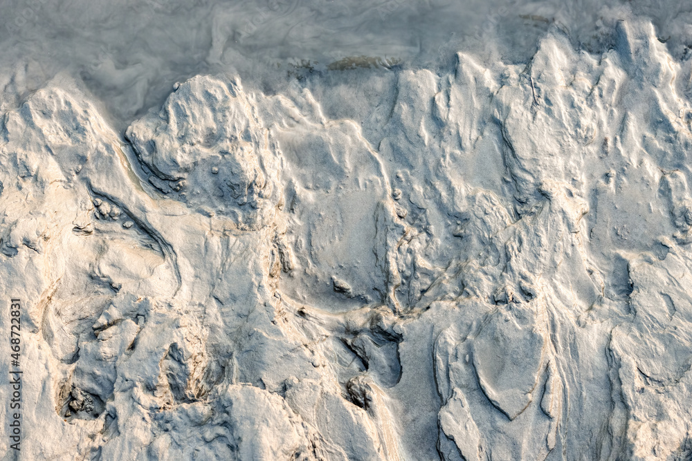 Fototapeta premium Wet sand on the river bank close up top view