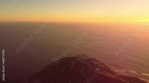 Aerial sunset view of Cape Finisterre Lighthouse the end of the earth famous tourist destination in Galicia northern Spain region photo