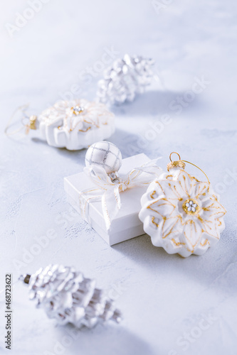 Christmas ornaments and small present in white