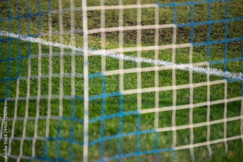 Football goal net. Blurred background, soccer field, penalty line