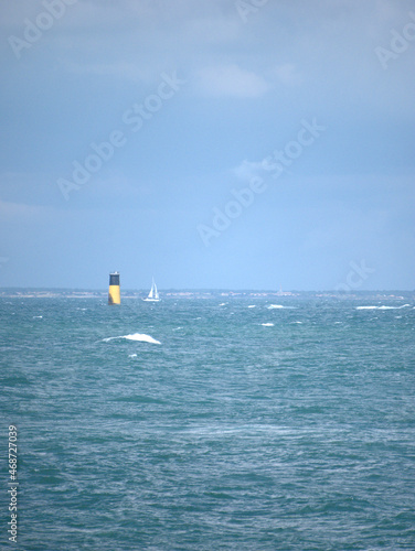 boat passing buoy on the ocean