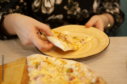 A woman eats pizza with her hands