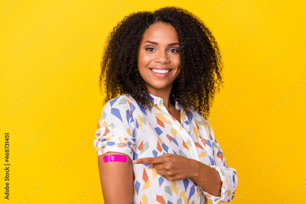 Photo of optimistic young wavy hairdo lady index arm wear white blouse isolated on yellow background Photo of optimistic young wavy hairdo lady index arm wear white blouse isolated on yellow background