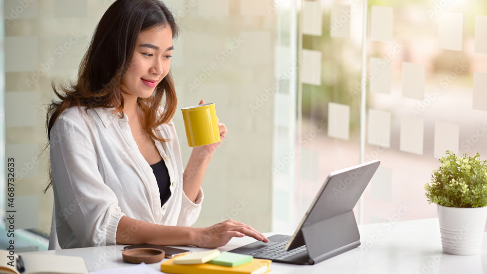 Beautiful female entrepreneur working on a business project on a tablet. Beautiful female entrepreneur working on a business project on a tablet.