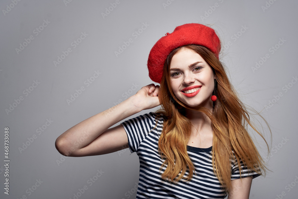 beautiful woman in a striped t-shirt red lips gesture with his hands Fresh air beautiful woman in a striped t-shirt red lips gesture with his hands Fresh air