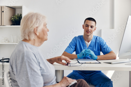 elderly woman talking to the doctor in the medical office
