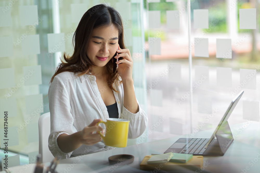 Freelancer sitting in coffee during talking on the phone Freelancer sitting in coffee during talking on the phone