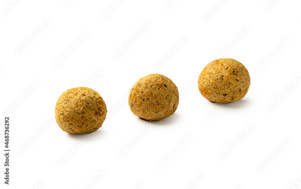 Three falafels, deep-fried balls of crushed legumes, chickpeas on a white background Three falafels, deep-fried balls of crushed legumes, chickpeas on a white background