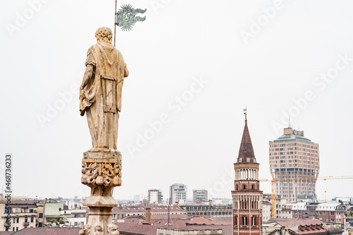Statue of a man with a standard in his hands on the spire of the Duomo. Milan  Italy