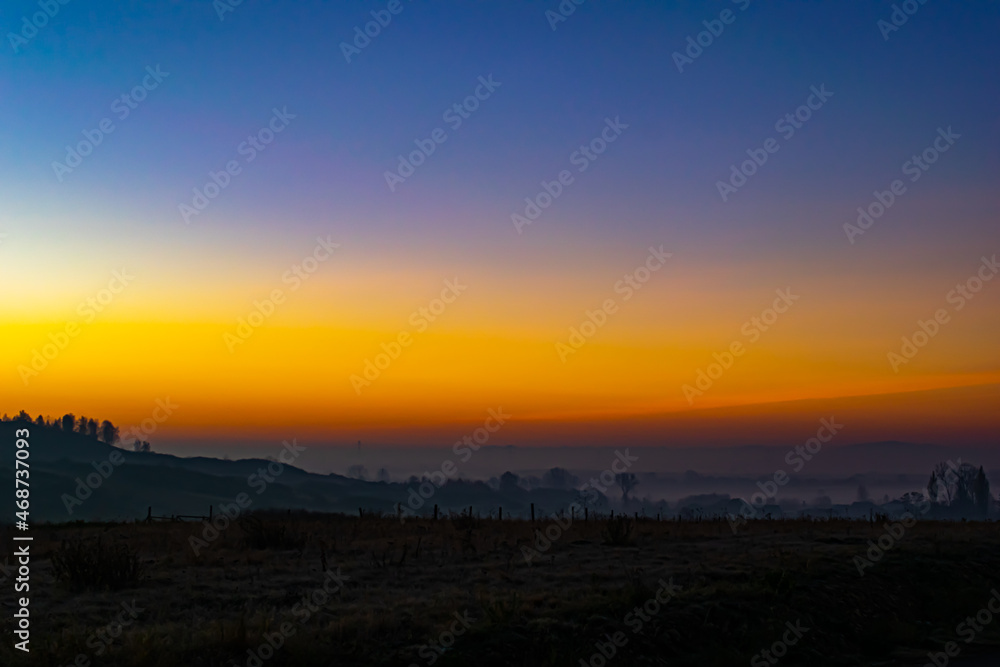 Autumn sunrise in Poland over a misty valley Autumn sunrise in Poland over a misty valley