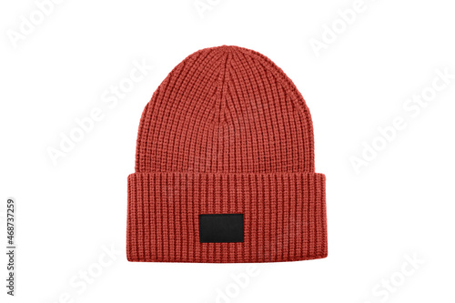 Red knitted beanie hat with black unbranded mockup label isolated on white background.