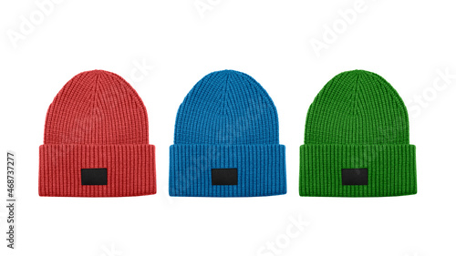 Photography Set of three colorful knitted beanie hats with black unbranded mockup label isolated on white background