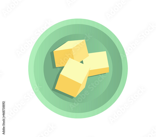 Pieces of butter lie on a saucer isolated on white. Top view.