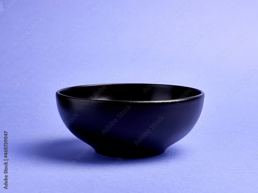 Black bowl on colorful background Black bowl on colorful background