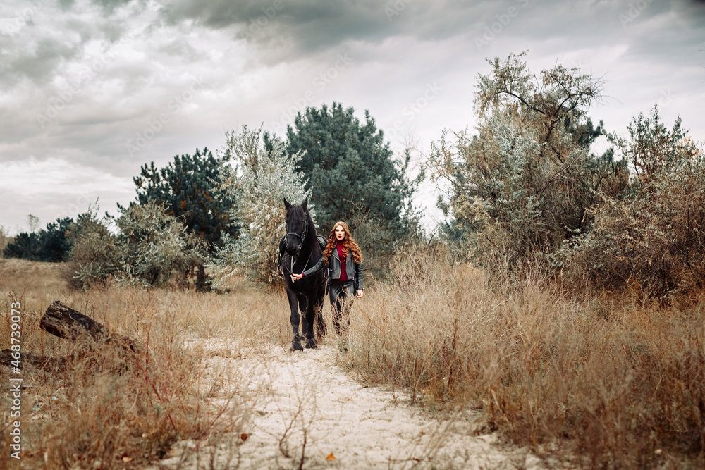 Beautiful young woman posing with a horse outdoors, close up Beautiful young woman posing with a horse outdoors, close up