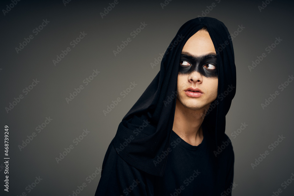 a man in a black mask Halloween costume Ghost dark background a man in a black mask Halloween costume Ghost dark background