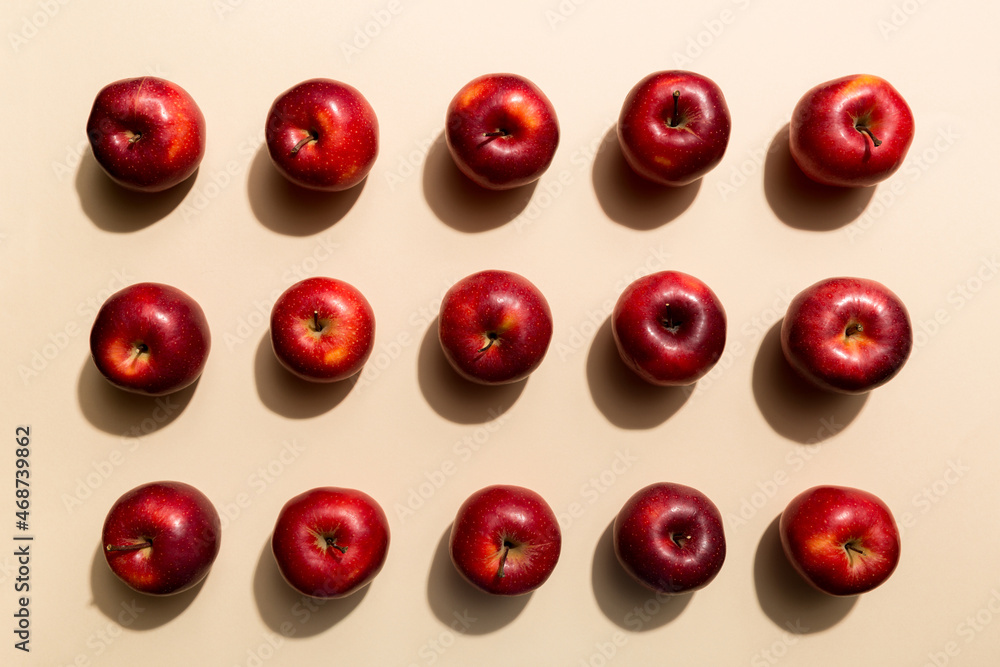 Many red apples on colored background, top view. Autumn pattern with fresh apple above view Many red apples on colored background, top view. Autumn pattern with fresh apple above view