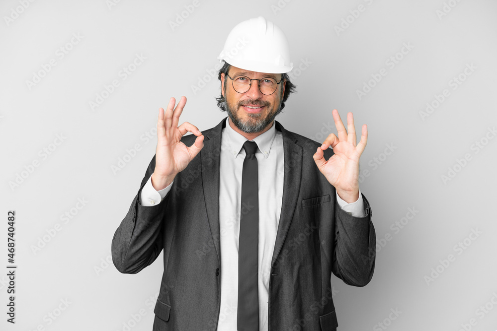 Young architect man with helmet over isolated background in zen pose Young architect man with helmet over isolated background in zen pose