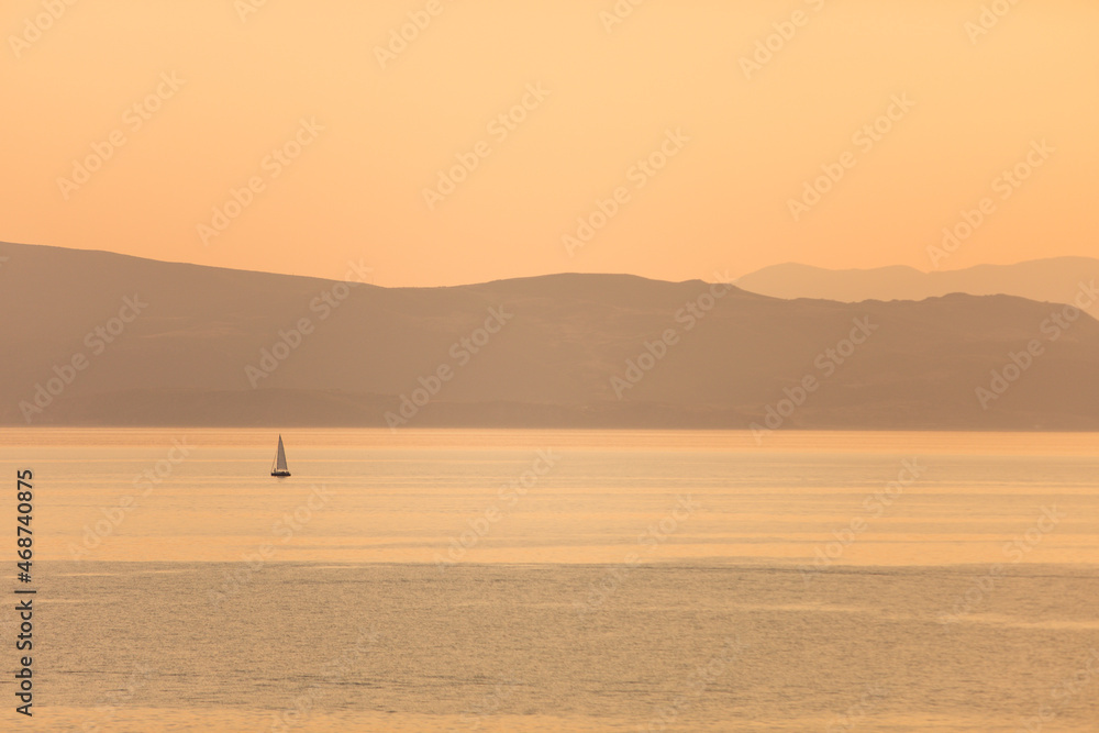 Sailing boat on a lake at dawn