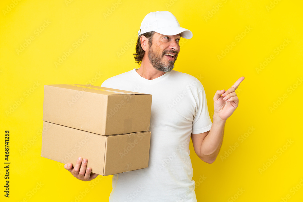 Delivery senior dutch man isolated on yellow background intending to realizes the solution while lifting a finger up Delivery senior dutch man isolated on yellow background intending to realizes the solution while lifting a finger up
