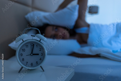 Woman with insomnia lying in bed with open eyes. Girl in bed suffering insomnia and sleep disorder thinking about her problem at night. Woman in bed late night trying to sleep suffering insomnia