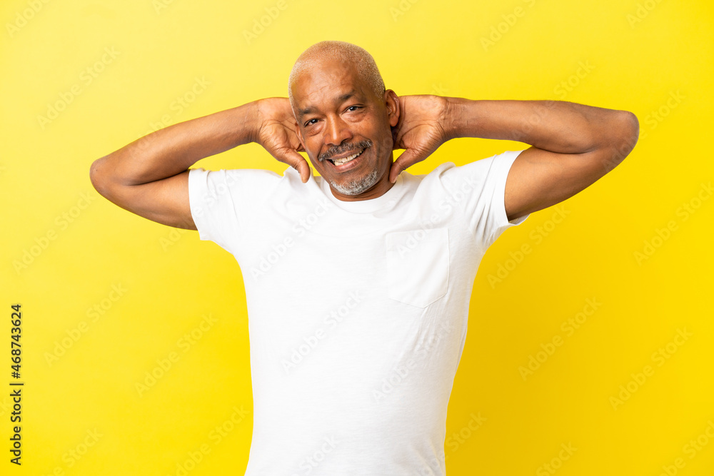 Cuban Senior isolated on yellow background laughing Cuban Senior isolated on yellow background laughing