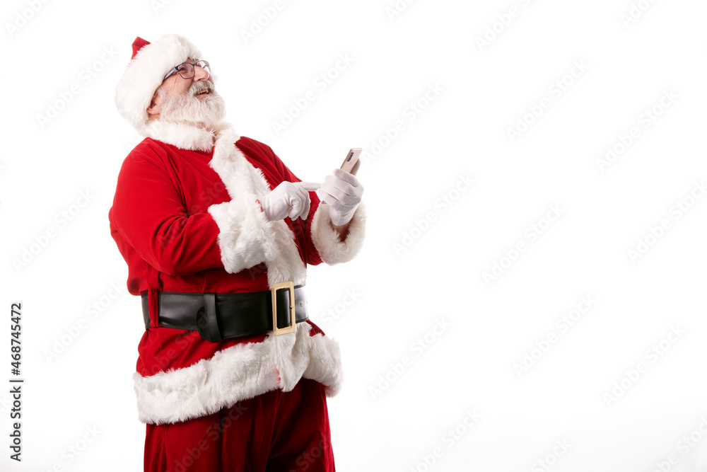 Santa Claus using a mobile phone on white background Santa Claus using a mobile phone on white background
