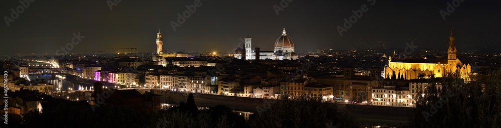 Cityscape of Florence at evening with Old Bridge, Palace of Town Hall, Cathedral of Santa Maria del Fiore and Basilica of the Holy Cross illuminated during Christmas period.