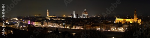 Cityscape of Florence at evening with Old Bridge, Palace of Town Hall, Cathedral of Santa Maria del Fiore and Basilica of the Holy Cross illuminated during Christmas period.