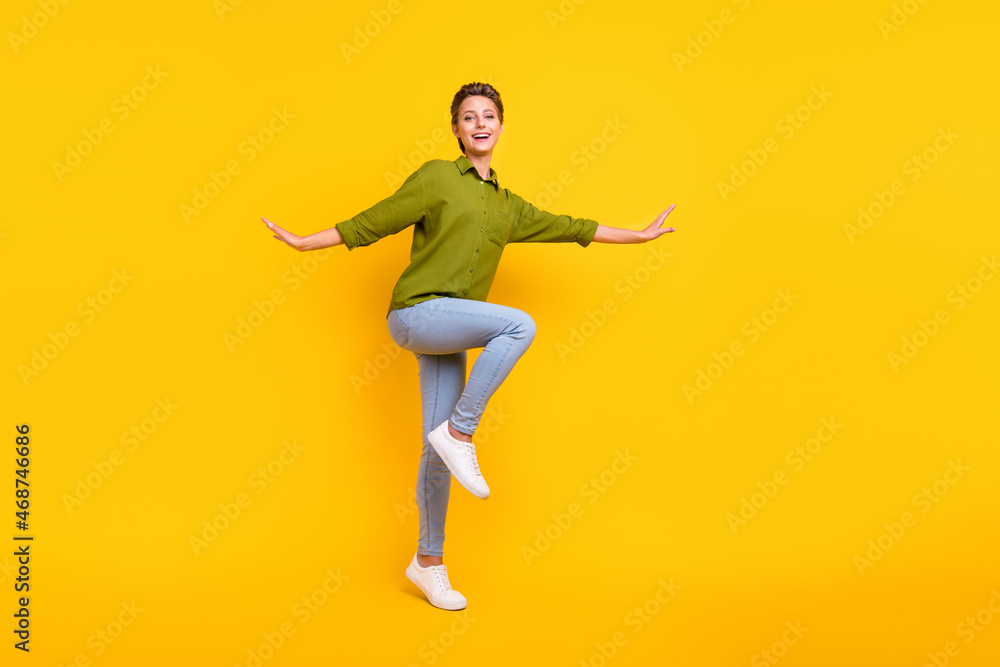 Photo of carefree dancer party lady enjoy disco move wear green shirt isolated yellow color background