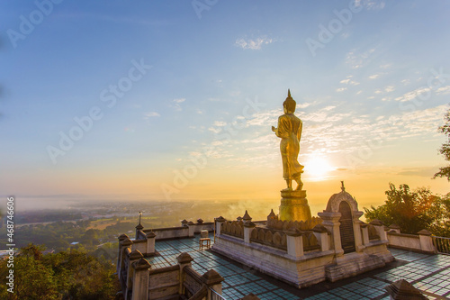 Golden buddha statue inside Phra That Khao Noi temple the temple is located on the hillin the morning with sunshine and bright sky, it is a major tourist attraction of Nan, Thailand. © nut_foto