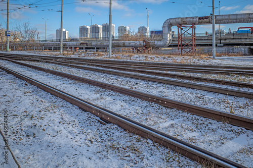 Tram tracks against the backdrop of the urban landscape on a cold winter morning